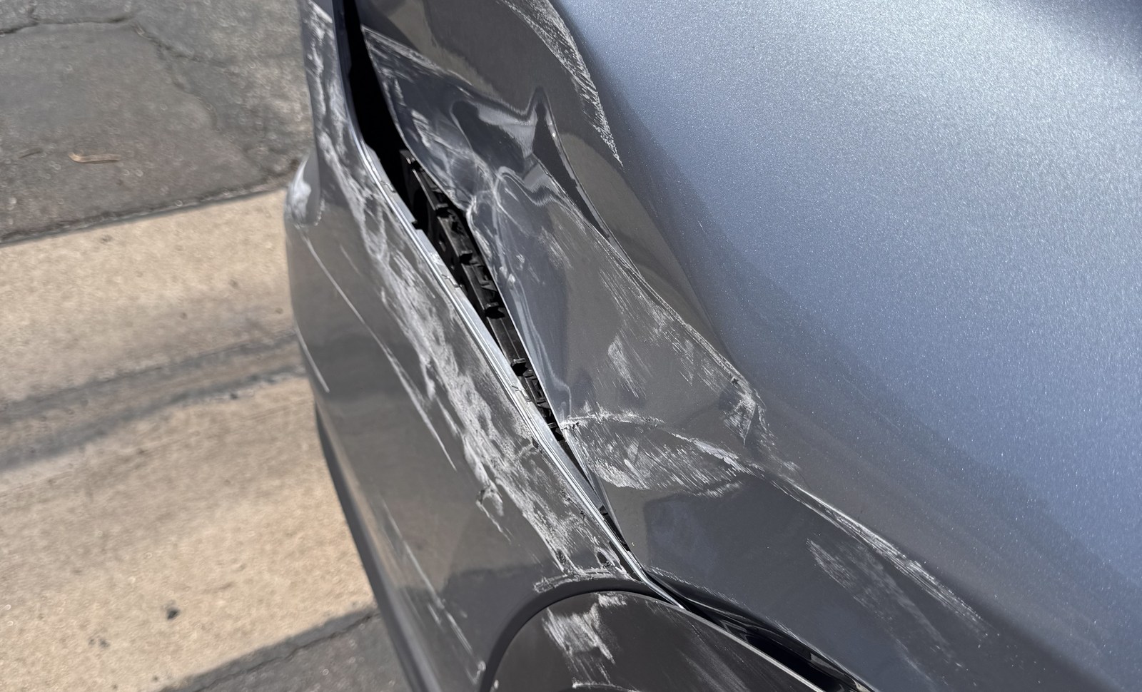 Rear-quarter and bumper-seam damage before an in-person inspection