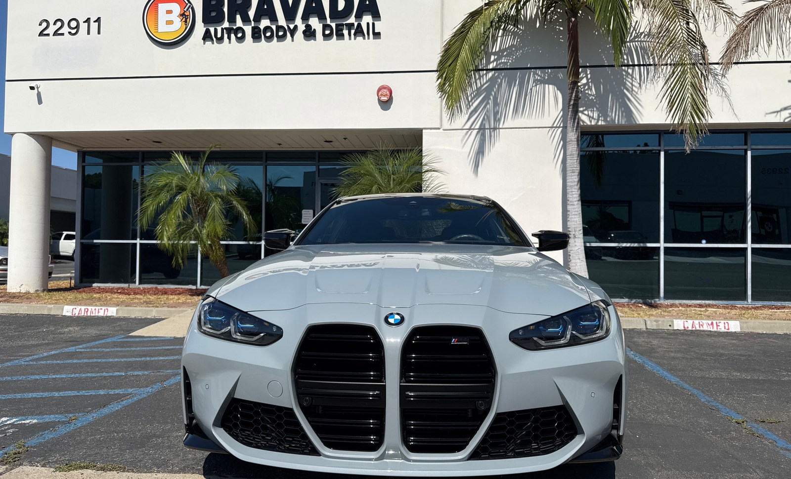 Finished white coupe outside Bravada's Yorba Linda shop