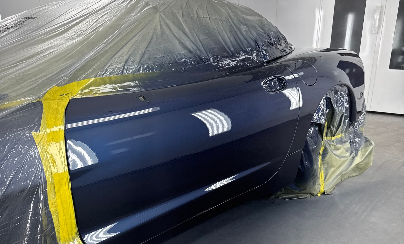 Vehicle masked in Bravada's paint booth during visible preparation